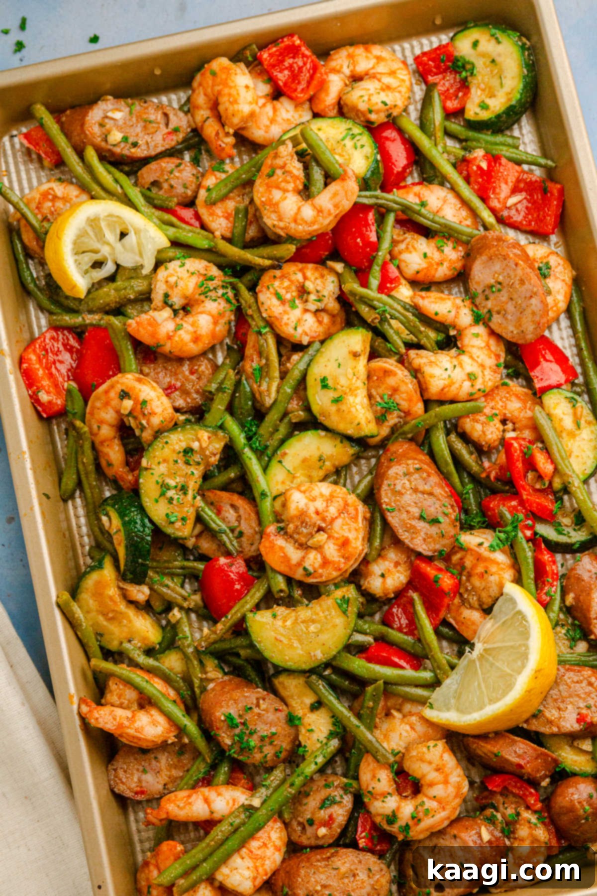 Cajun Shrimp and Sausage Sheet Pan Bake 2 Overhead long portrait image of sheet pan Cajun shrimp and sausage.