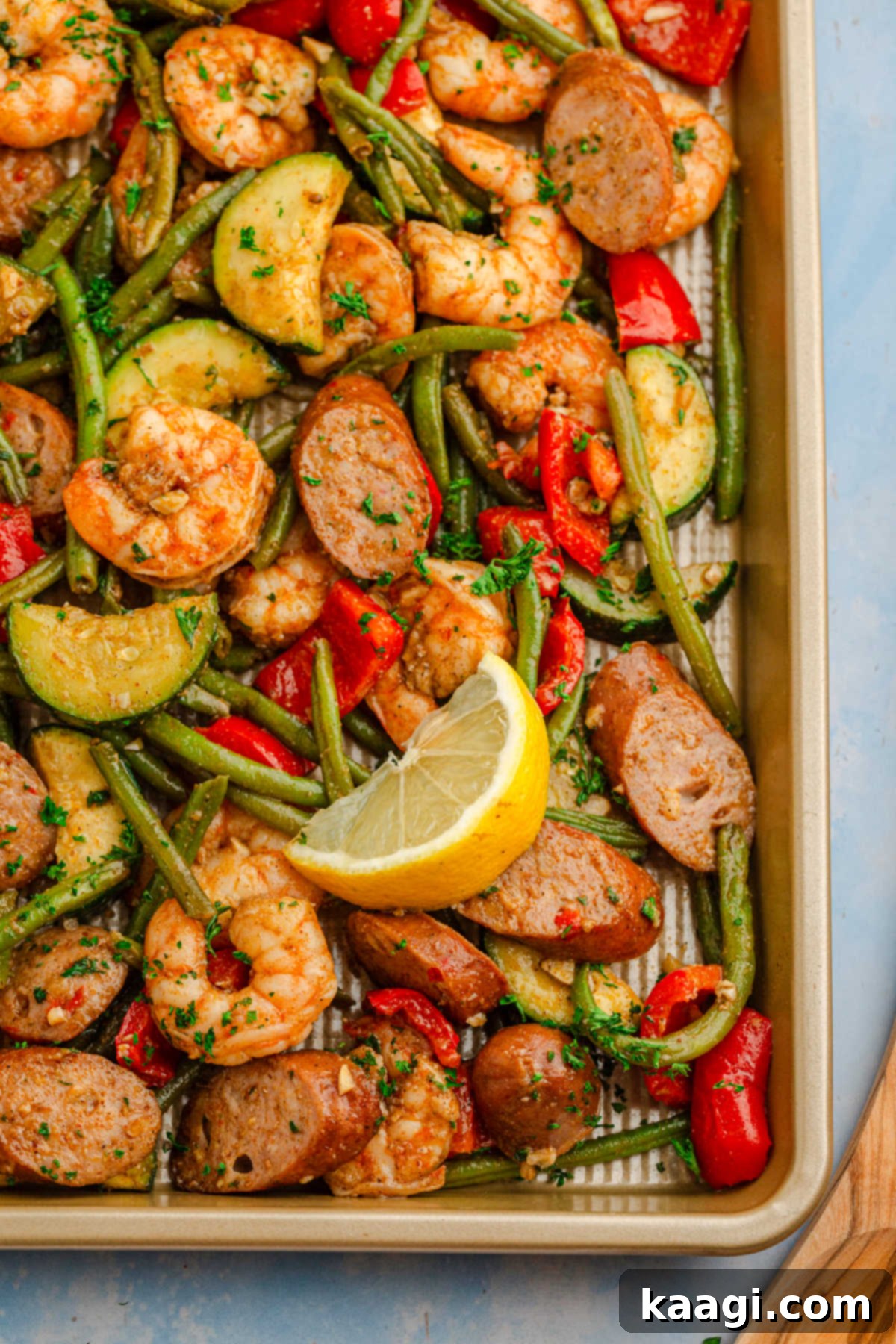 Cajun Shrimp and Sausage Sheet Pan Bake 7 Overhead shot of the corner of a sheet pan filled with Cajun shrimp and sausage.