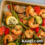 Cajun Shrimp and Sausage Sheet Pan Bake 8 Close up of a corner of a sheet pan Cajun shrimp and sausage.