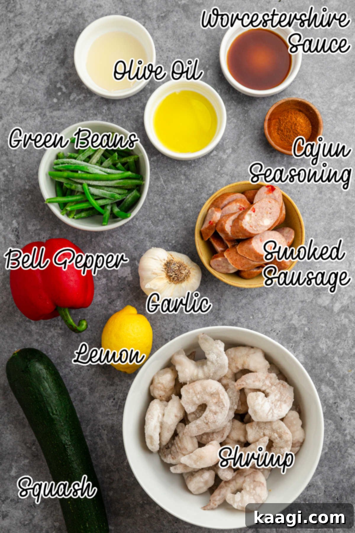 Overhead shot of ingredients needed to make a Sheet Pan Cajun shrimp and sausage recipe.