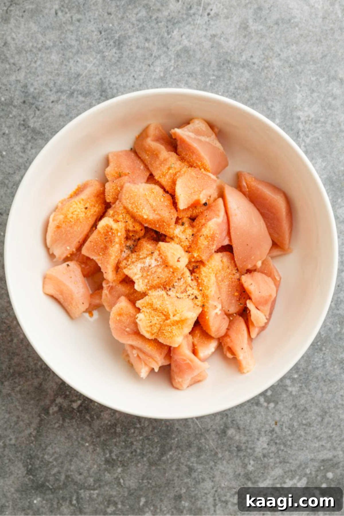 Louisiana Chicken Stroganoff 4 A large bowl with seasoned chicken pieces.