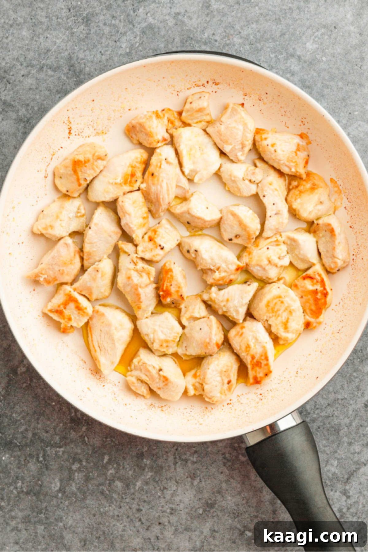 Louisiana Chicken Stroganoff 5 Seasoned chicken pieces cooking in a large skillet.
