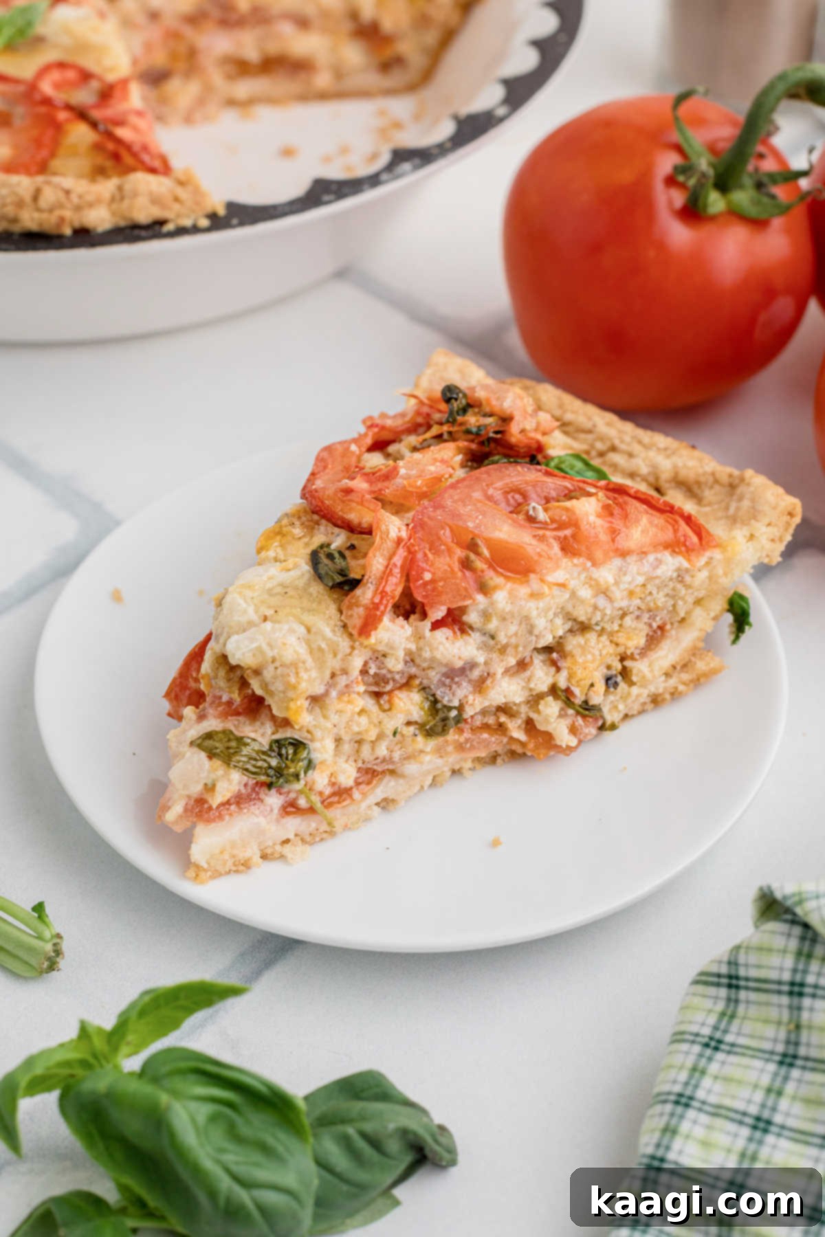 Dixie Tomato Tart 11 A perfectly sliced piece of Southern Tomato Pie, showcasing its golden crust and lush tomato and cheese filling.