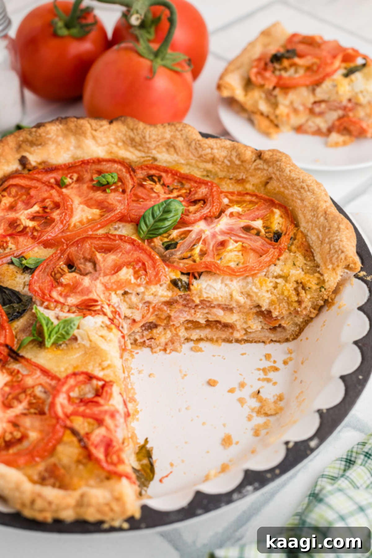 Dixie Tomato Tart 10 Side angle of a vintage tomato pie, with several slices already enjoyed, showing the delicious layers of tomatoes and cheese.