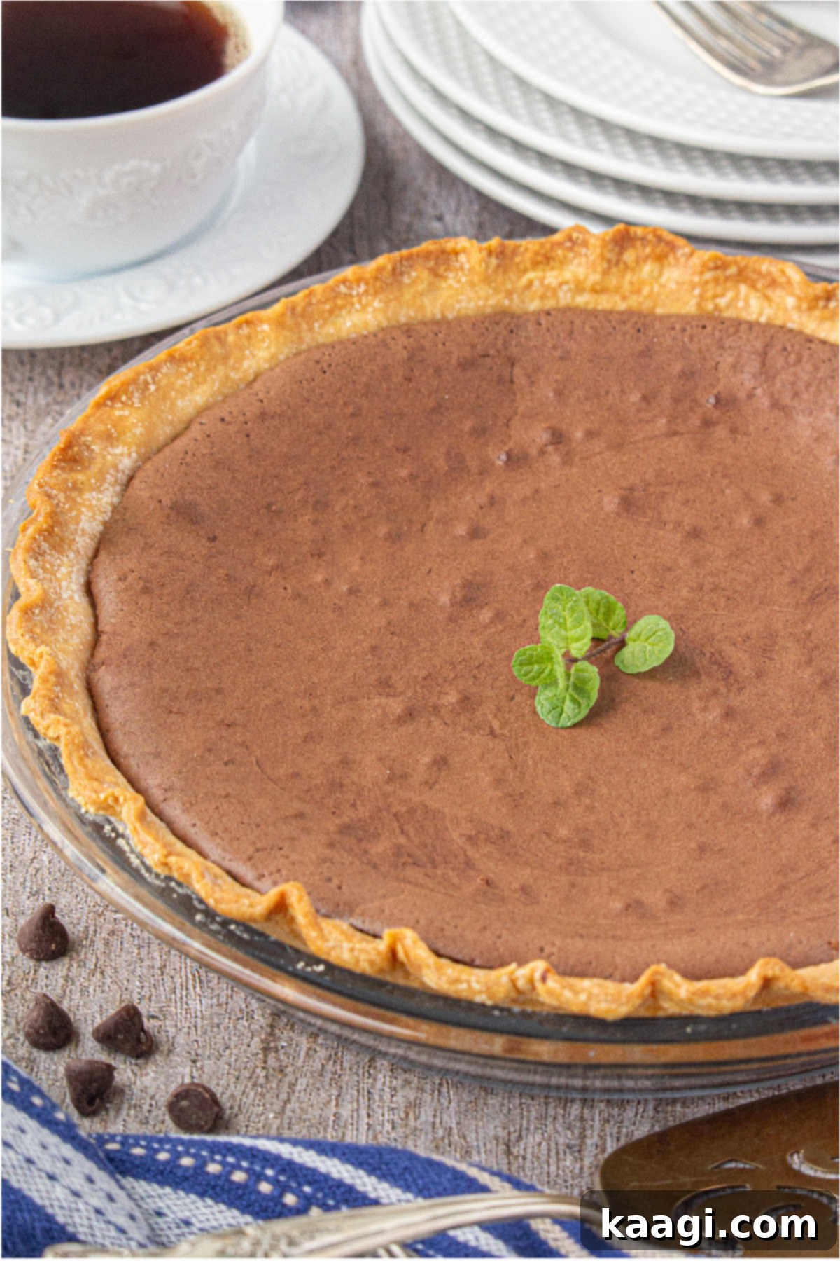 A perfectly baked Southern Chocolate Chess Pie, golden brown and glistening, sits cooling in its pie dish.