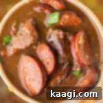 Swamp Hen Gumbo 8 Image cropped square of a ladle full of poule d'eau gumbo with andouille sausage.