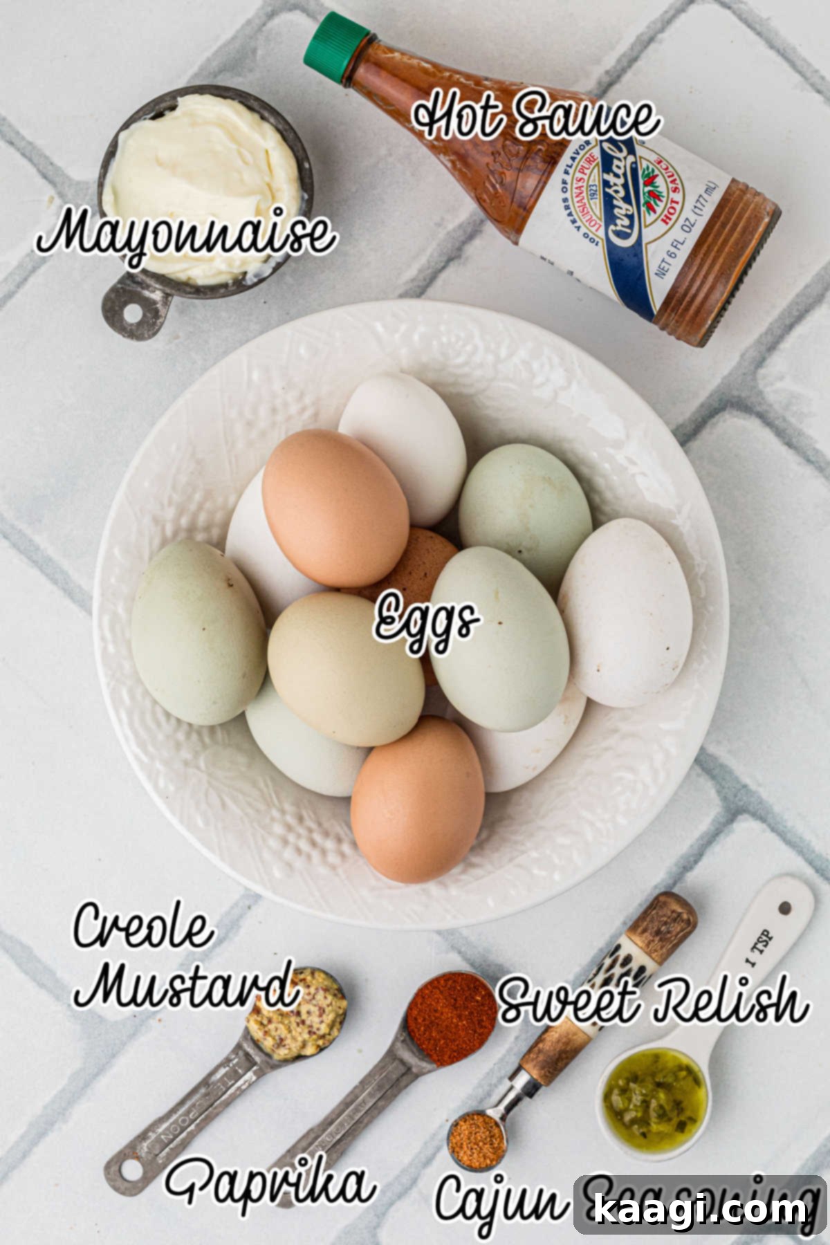 Fiery Cajun Deviled Eggs 3 Overhead shot of ingredients needed to make a Cajun deviled eggs recipe, including eggs, mayonnaise, mustard, seasoning, relish, and hot sauce.