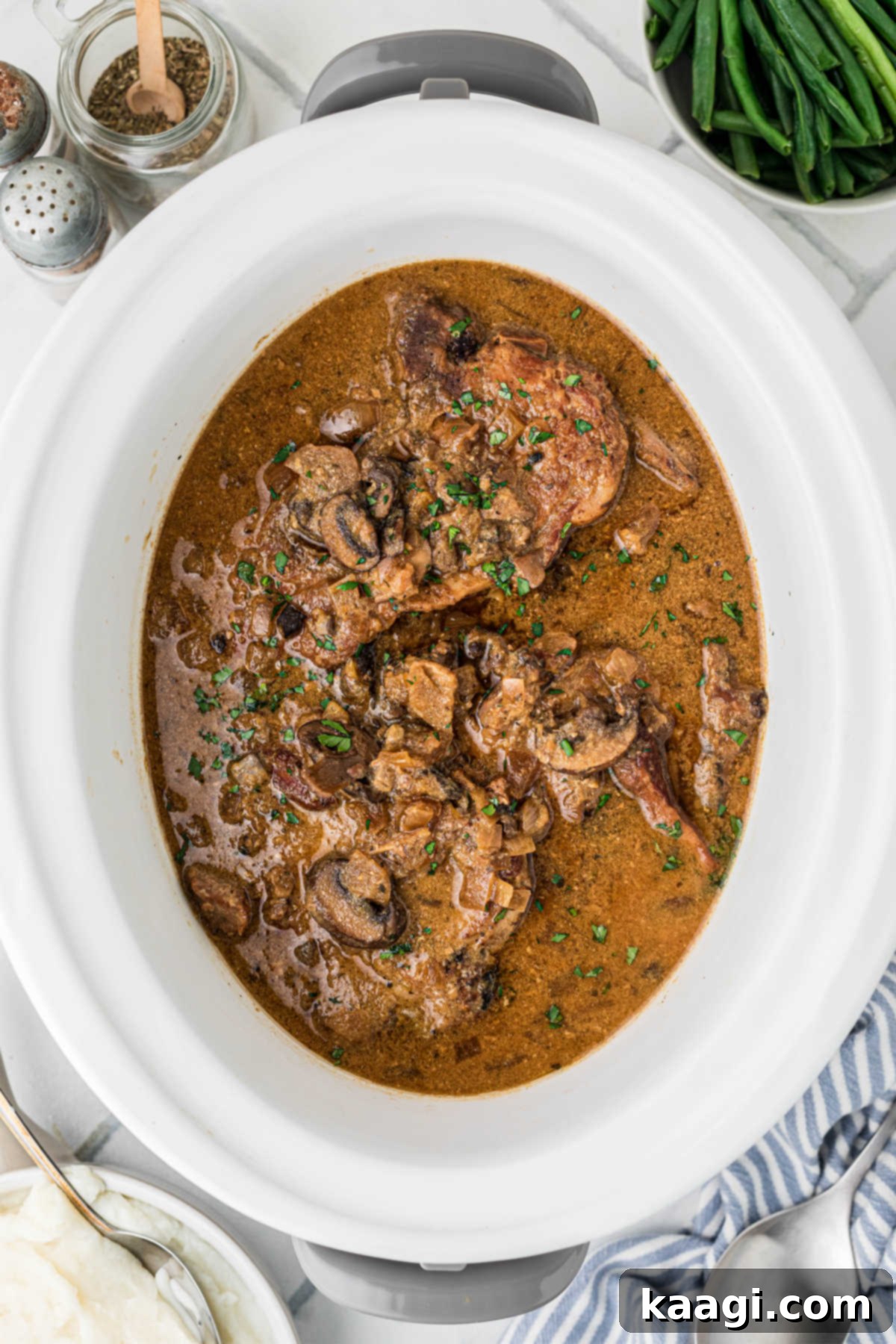 Overhead shot of a crock-pot smothered pork chops recipe.