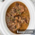 Overhead shot of a slow cooker smothered pork chops recipe.