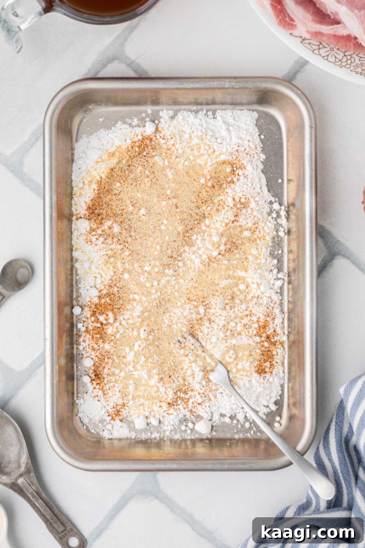 A large pan filled with flour and seasoning.