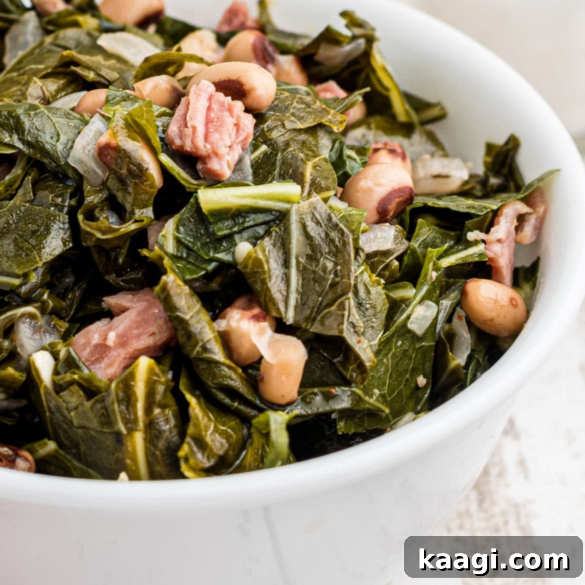Elevate Your Plate with Essential Southern Sides 15 Close up of a bowl of comforting Southern black eyed peas and tender collard greens, a traditional pairing.