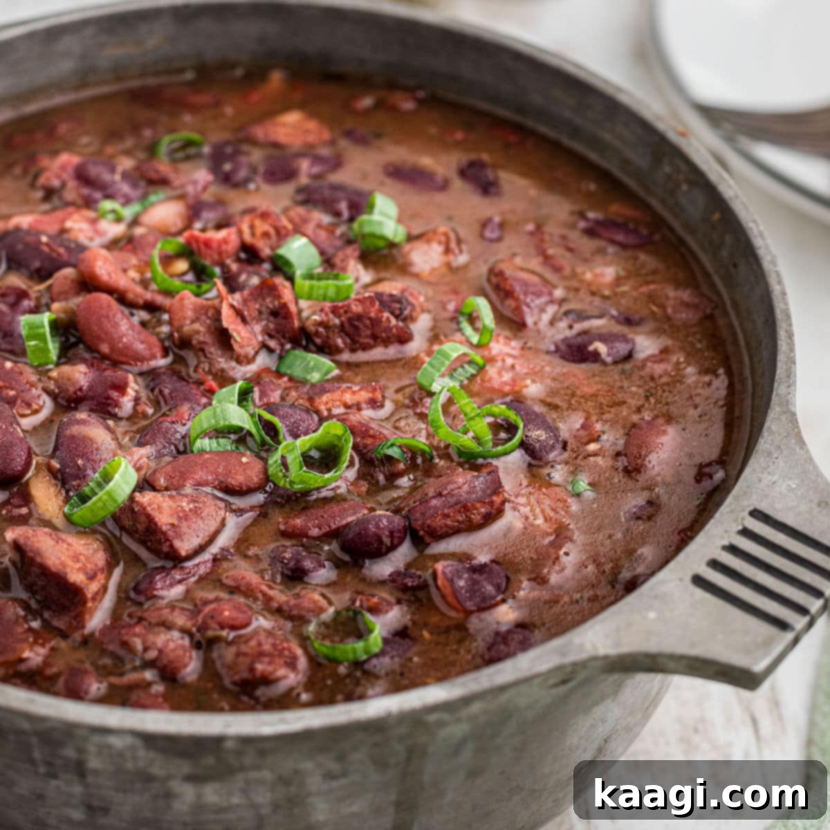 Elevate Your Plate with Essential Southern Sides 29 A pot of rich red beans and rice with tender ham hocks, perfectly cropped square.