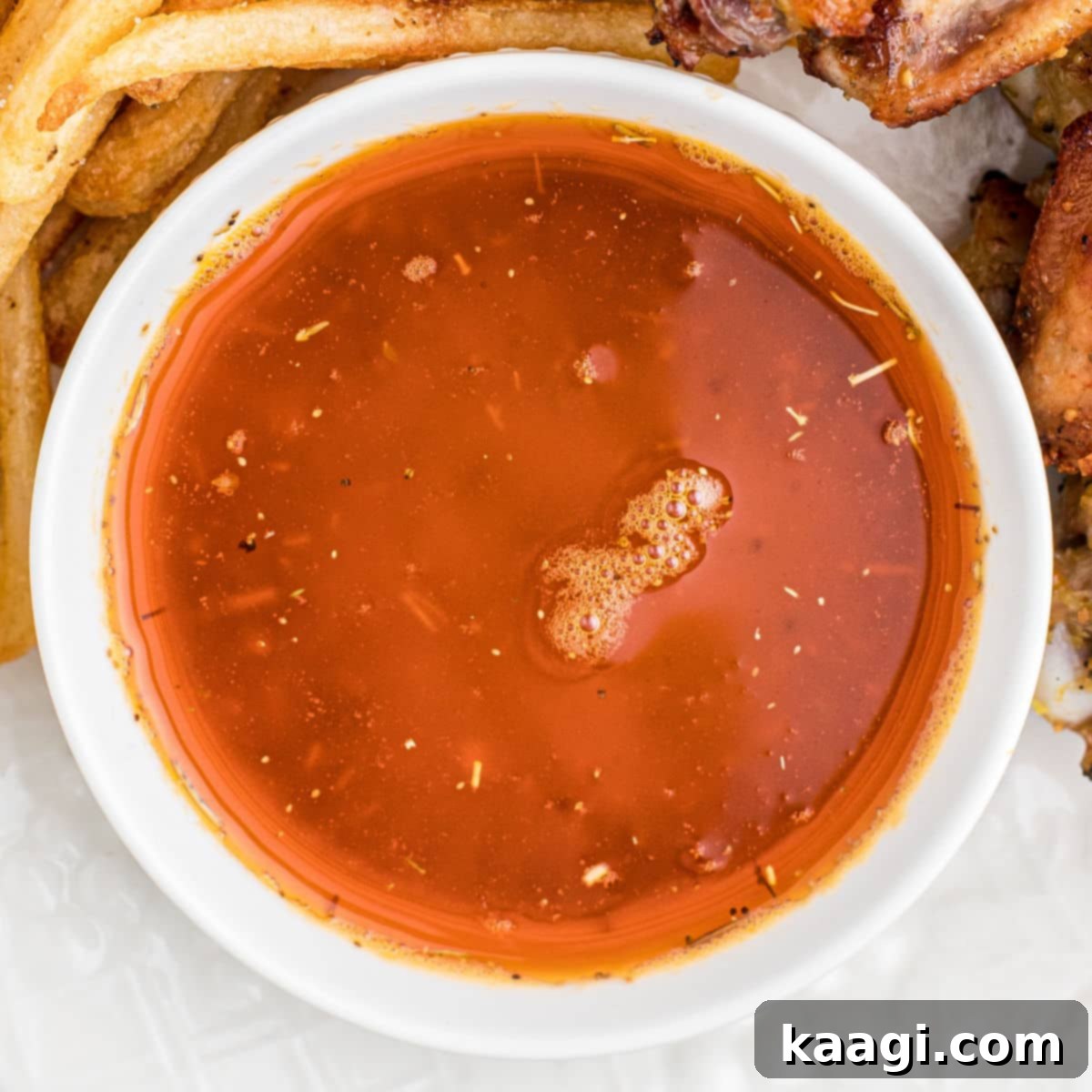 Elevate Your Plate with Essential Southern Sides 38 Close up of a bowl of rich Cajun butter sauce, perfect for dipping or drizzling.