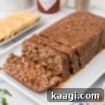 A loaf of mock hog head cheese, perfectly sliced and ready to serve.