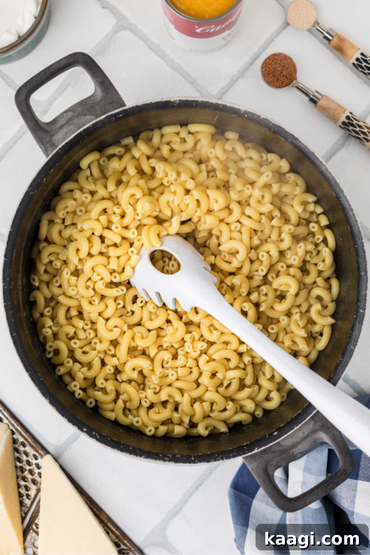 A pot of boiling water with macaroni noodles, cooked to al dente perfection.