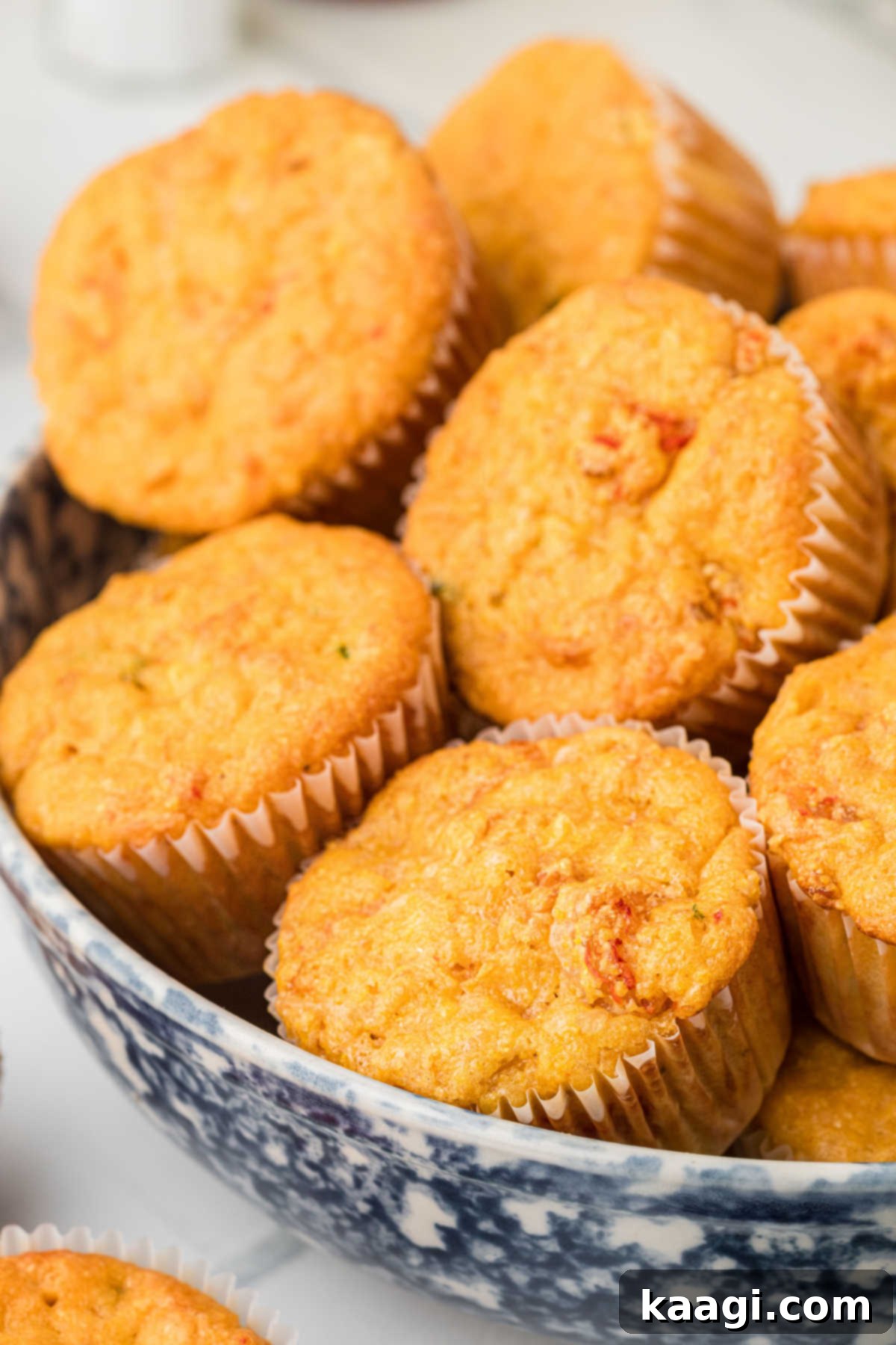 Cajun Crawfish Cornbread Muffins 10 A rustic, deep wooden bowl overflowing with numerous freshly baked, golden-brown crawfish cornbread muffins, steam gently rising, indicating a bountiful and warm serving, ready for guests.
