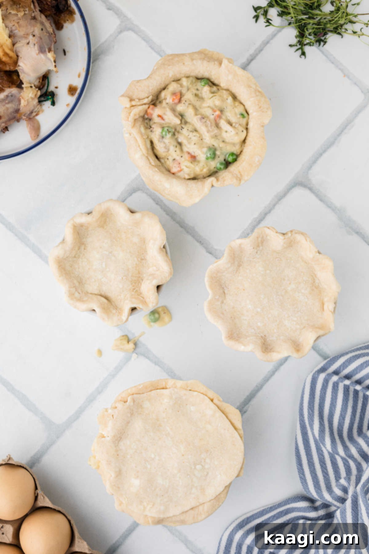 Comforting Mini Chicken Pot Pies 15 Top crusts added to mini chicken pot pies, with edges being crimped.