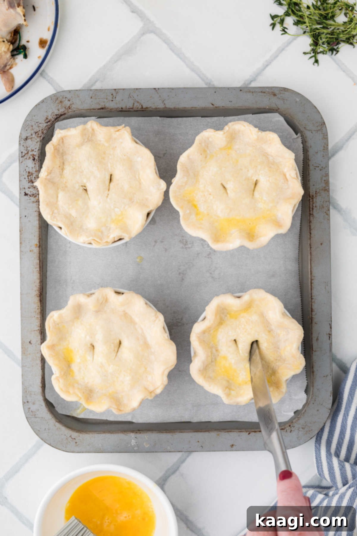 Comforting Mini Chicken Pot Pies 17 Mini Chicken Pot Pies, having slits cut into the top crusts with a knife for steam release.