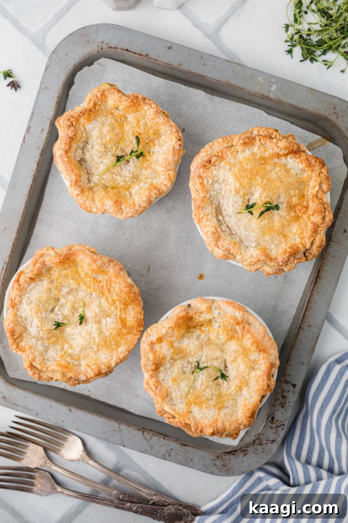 Comforting Mini Chicken Pot Pies 18 Overhead picture of four beautifully baked mini chicken pot pies, golden and inviting.
