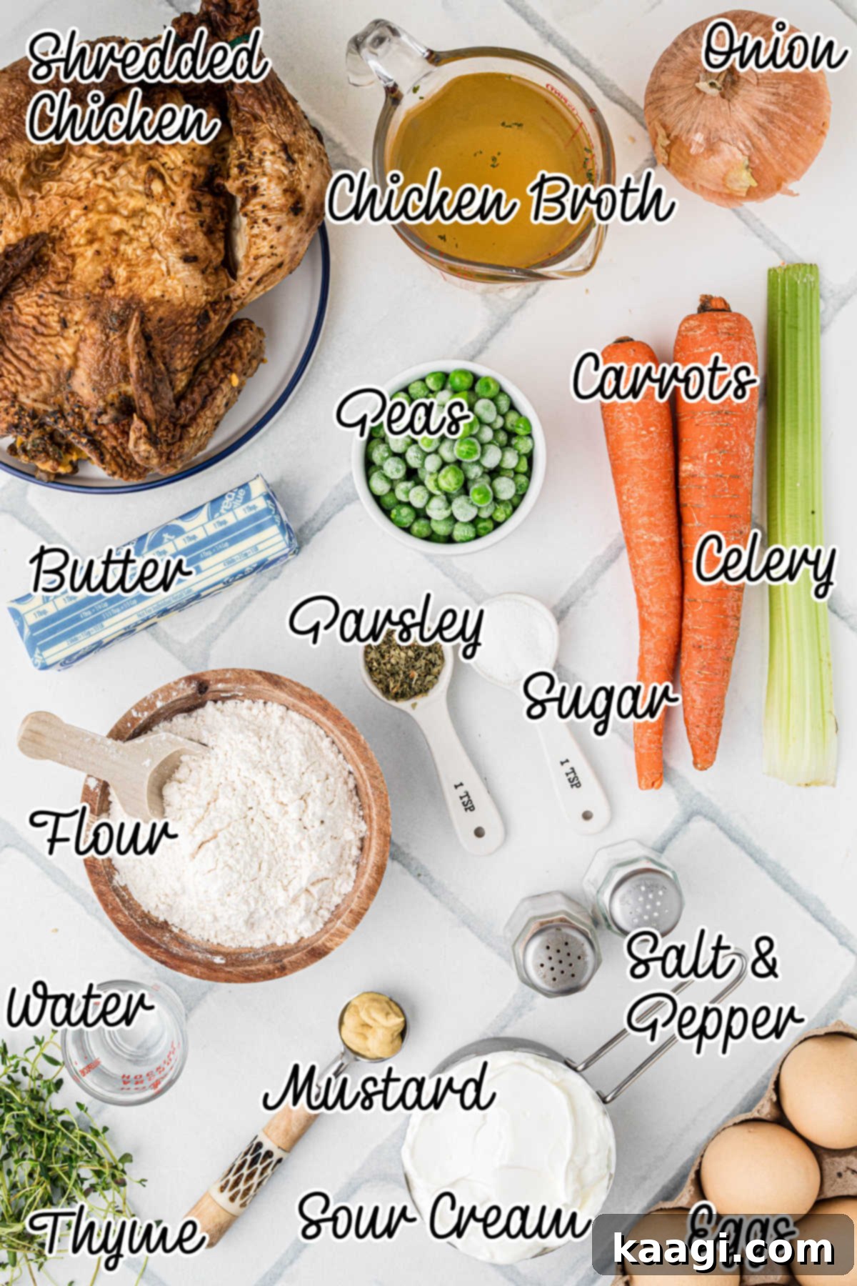 Comforting Mini Chicken Pot Pies 3 Overhead shot of fresh ingredients needed to make a mini chicken pot pie recipe, including butter, vegetables, and chicken.