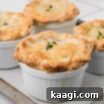 Comforting Mini Chicken Pot Pies 21 A square image of mini chicken pot pies, golden and ready to eat.