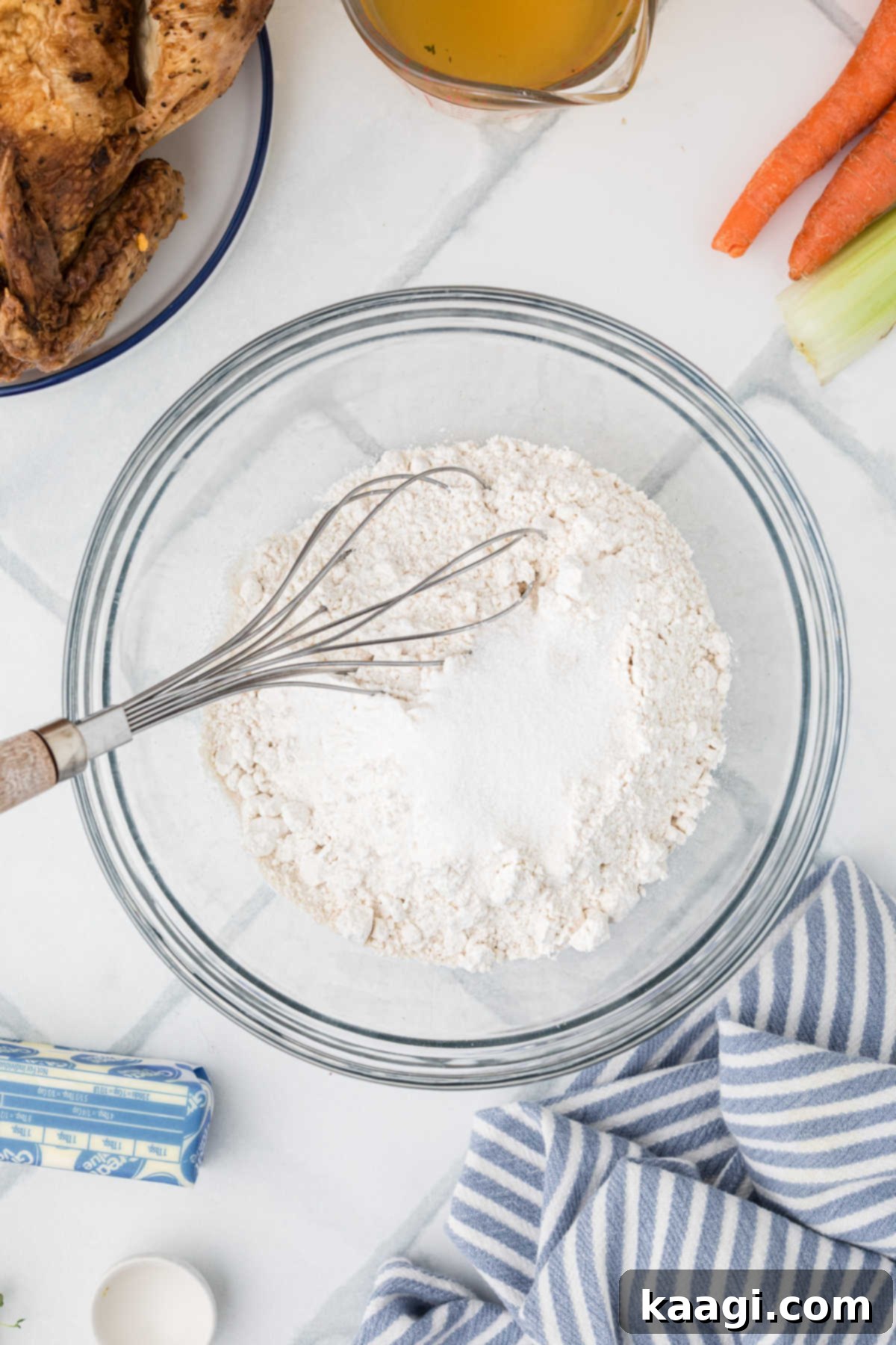 Comforting Mini Chicken Pot Pies 4 A large mixing bowl with flour, sugar, and salt, ready to be whisked together.