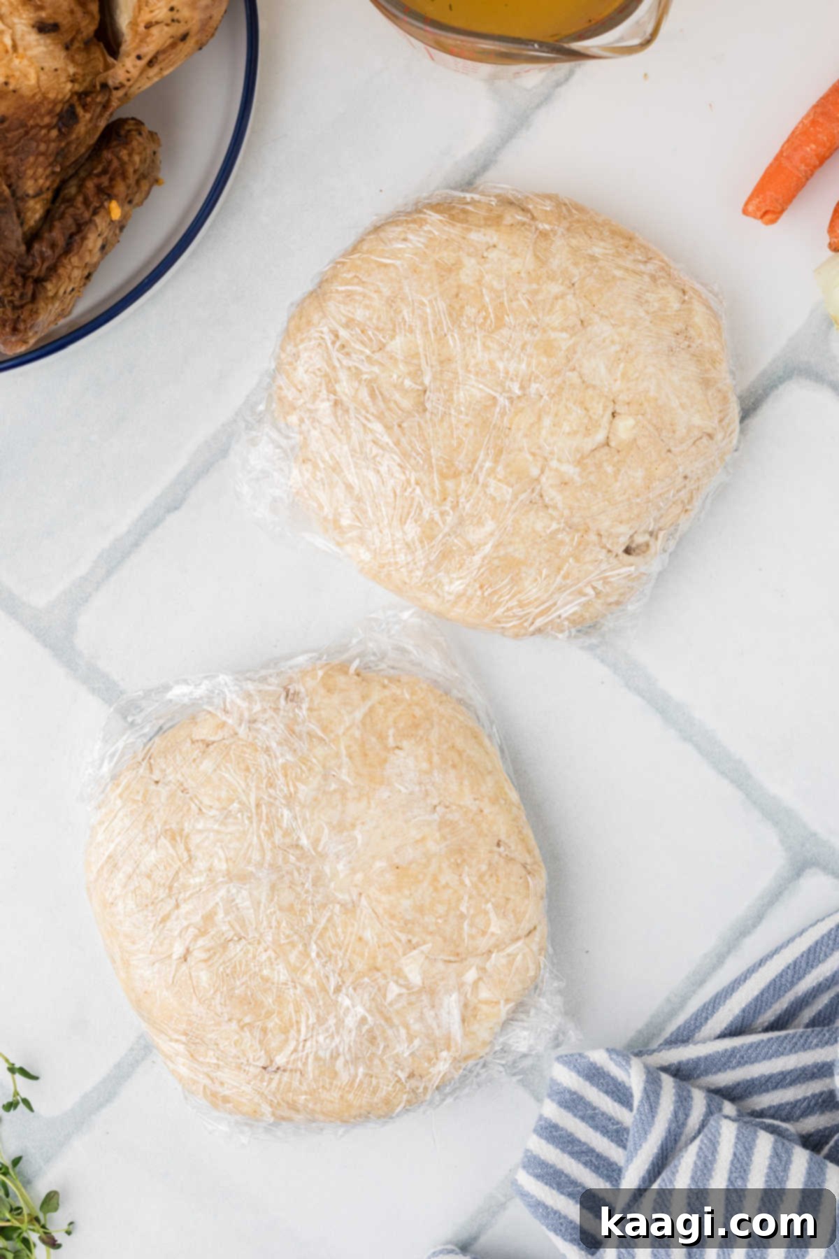Comforting Mini Chicken Pot Pies 7 Two discs of pie dough wrapped in plastic wrap, ready for chilling.