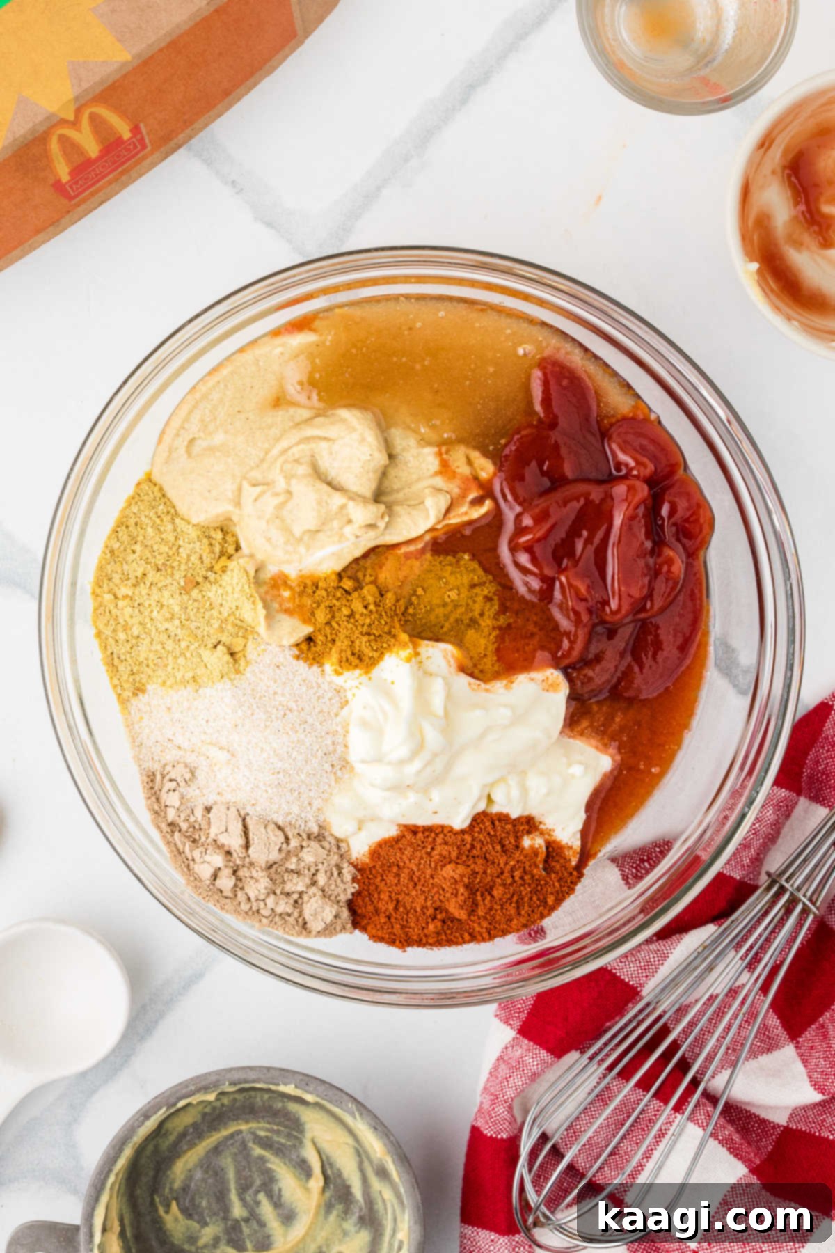 Ingredients needed to make a copycat McDonald's Cajun Sauce recipe all added to a mixing bowl.