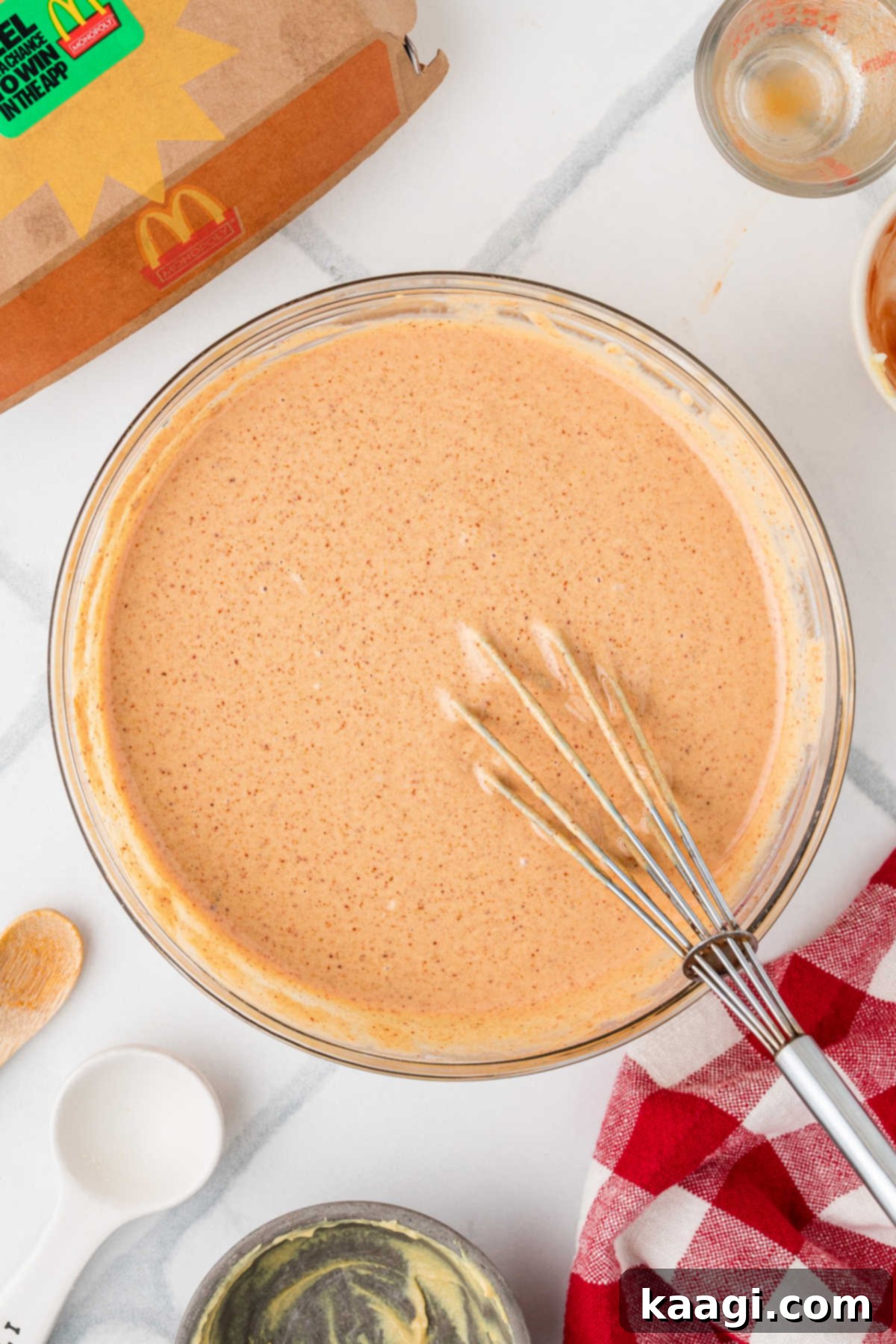 A large bowl of Cajun Sauce, with a whisk.