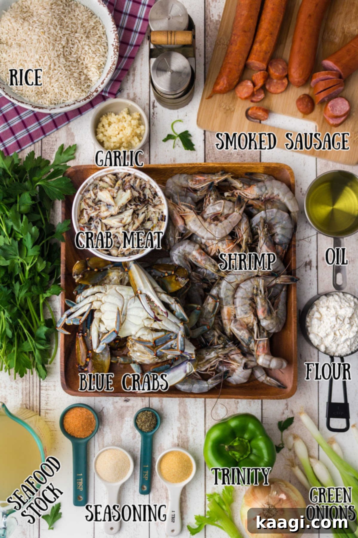 A vibrant selection of fresh ingredients including shrimp, crab, vegetables, and spices, laid out for a seafood gumbo.