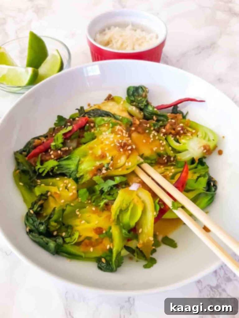 A vibrant close-up of Ginger Garlic Bok Choy Stir Fry, ready to be enjoyed with chopsticks.