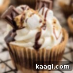 Close up of a finished S'mores cupcake with fluffy marshmallow frosting.