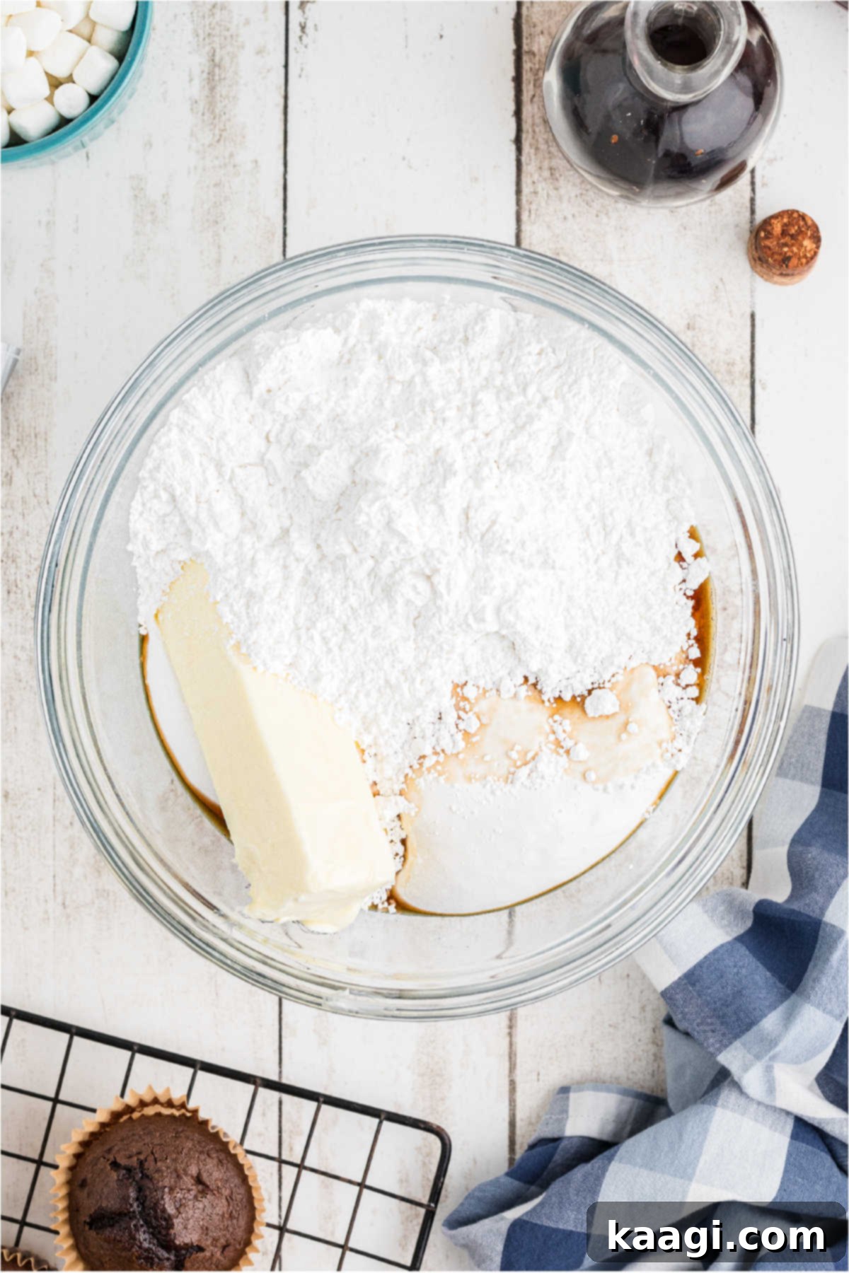 A large mixing bowl containing softened butter, powdered sugar, and vanilla extract, ready to be beaten for the marshmallow frosting.