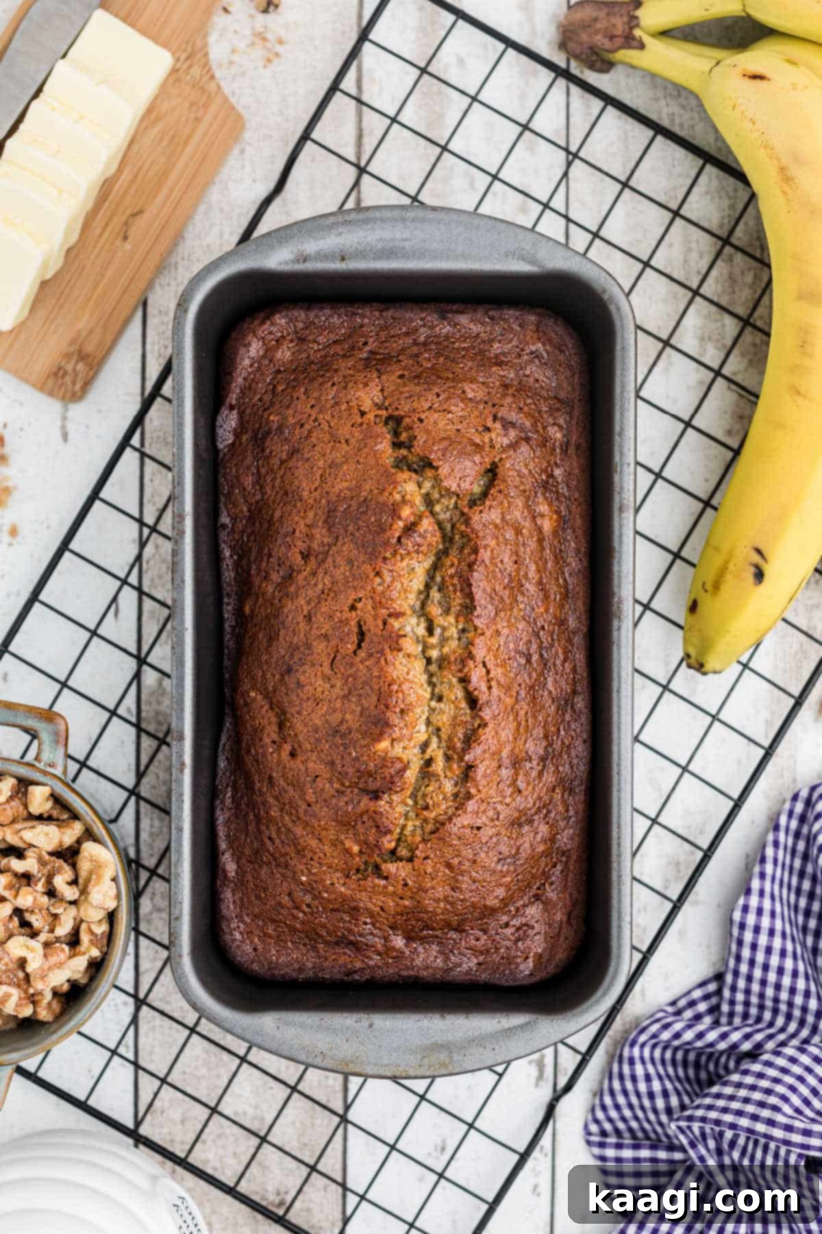 Mayo Magic Banana Bread 2 a loaf tin with banana bread on a cooling rack