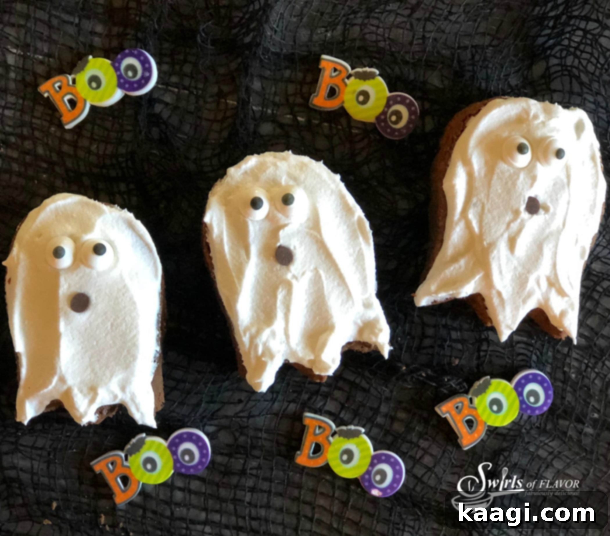Fudgy Halloween Ghost Brownies, decorated with white ghost shapes made from frosting and candy eyes.