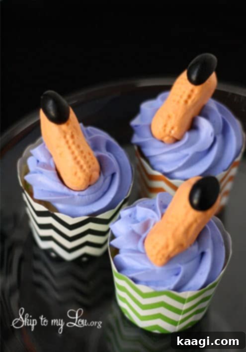 A selection of easy Halloween cupcakes, some decorated with candy witch fingers for a silly and spooky effect.