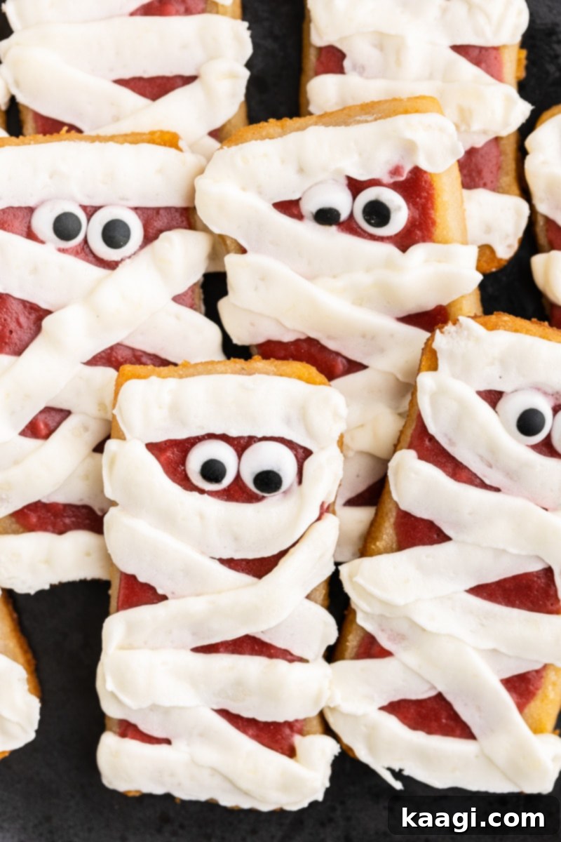 Keto Cheesecake Mummy Cookies decorated with cream cheese frosting strips resembling mummy bandages.