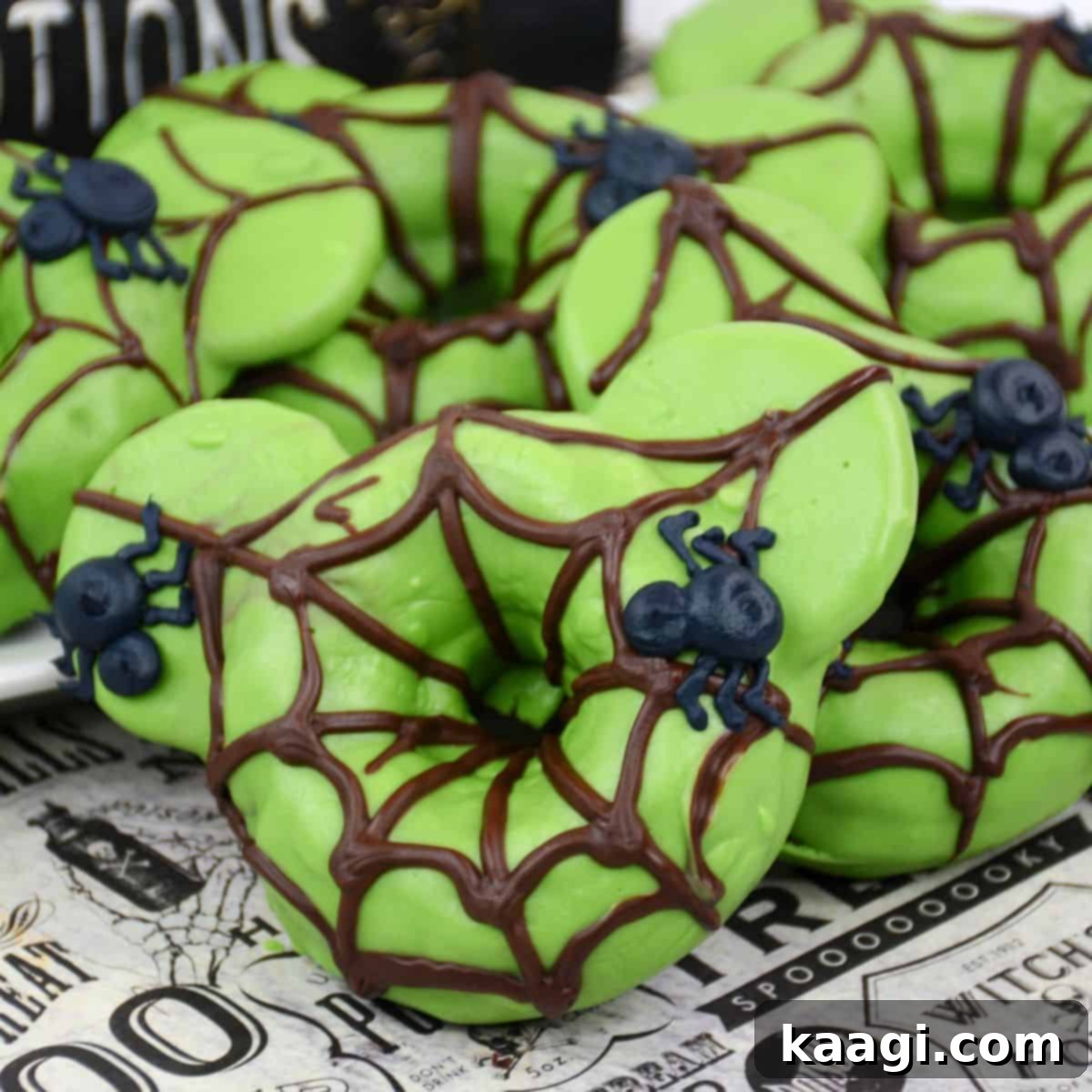 Freshly baked spider Halloween donuts, artfully decorated with chocolate frosting webs and cute candy spider bodies.