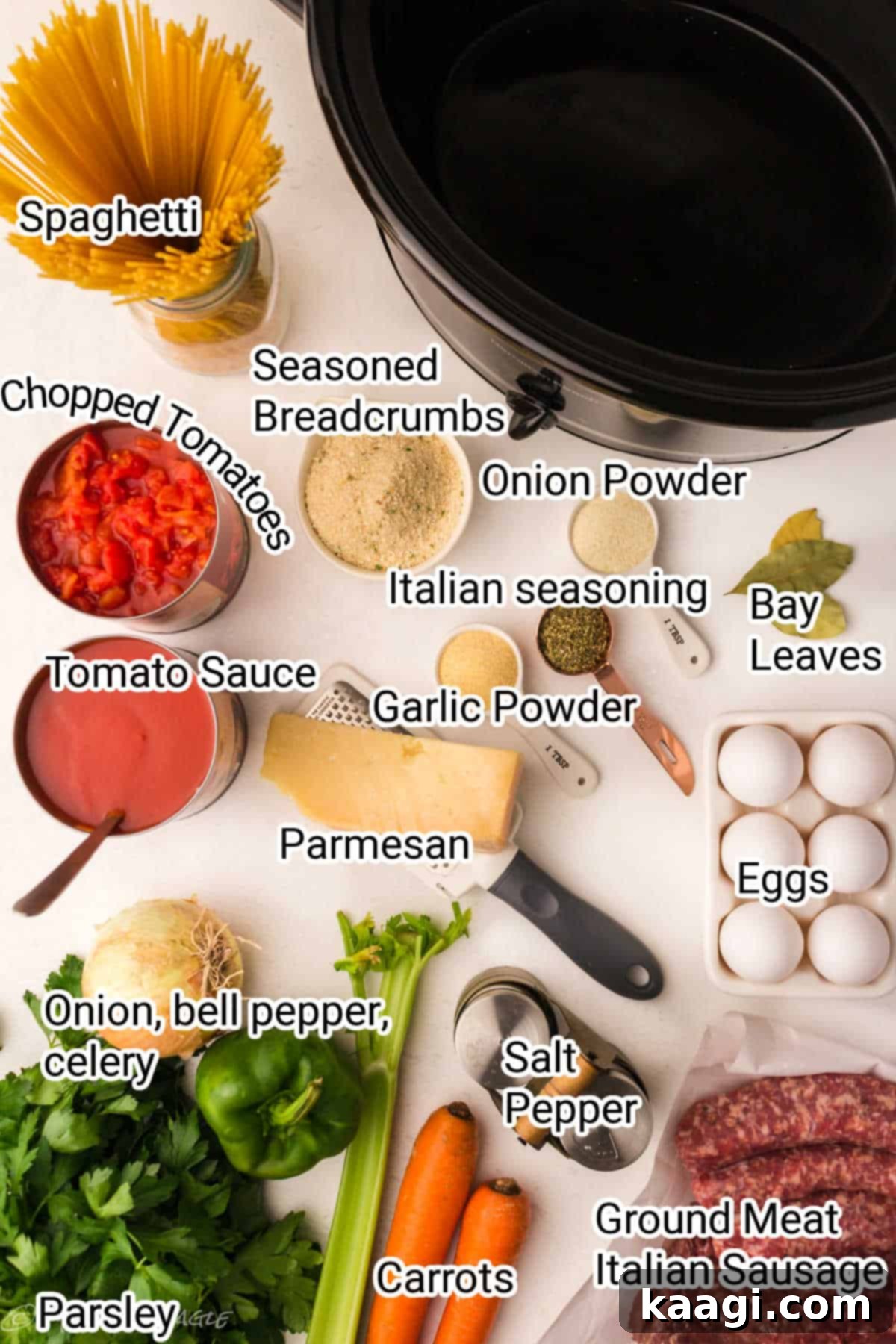 All the fresh ingredients for spaghetti and meatballs laid out neatly on a wooden board, ready for preparation.