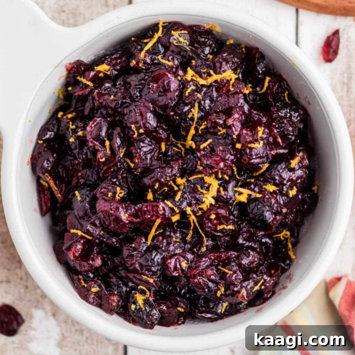 Close up overhead image of a bowl of homemade dried cranberry sauce with orange zest.