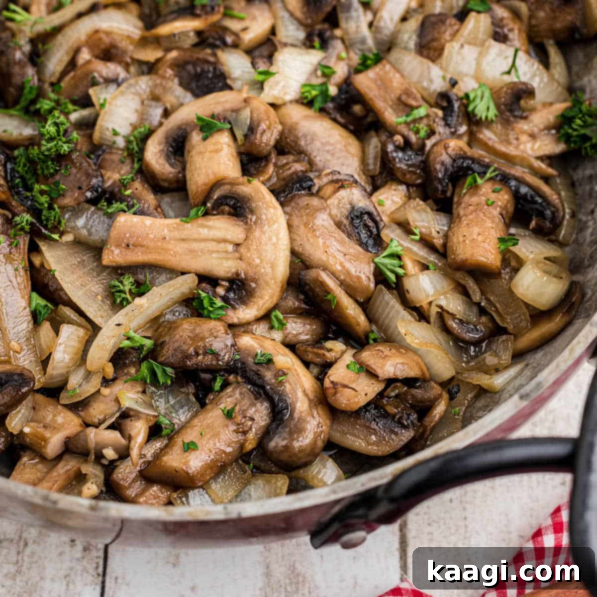 Close up of a skillet brimming with perfectly sautéed Texas Roadhouse Mushrooms.