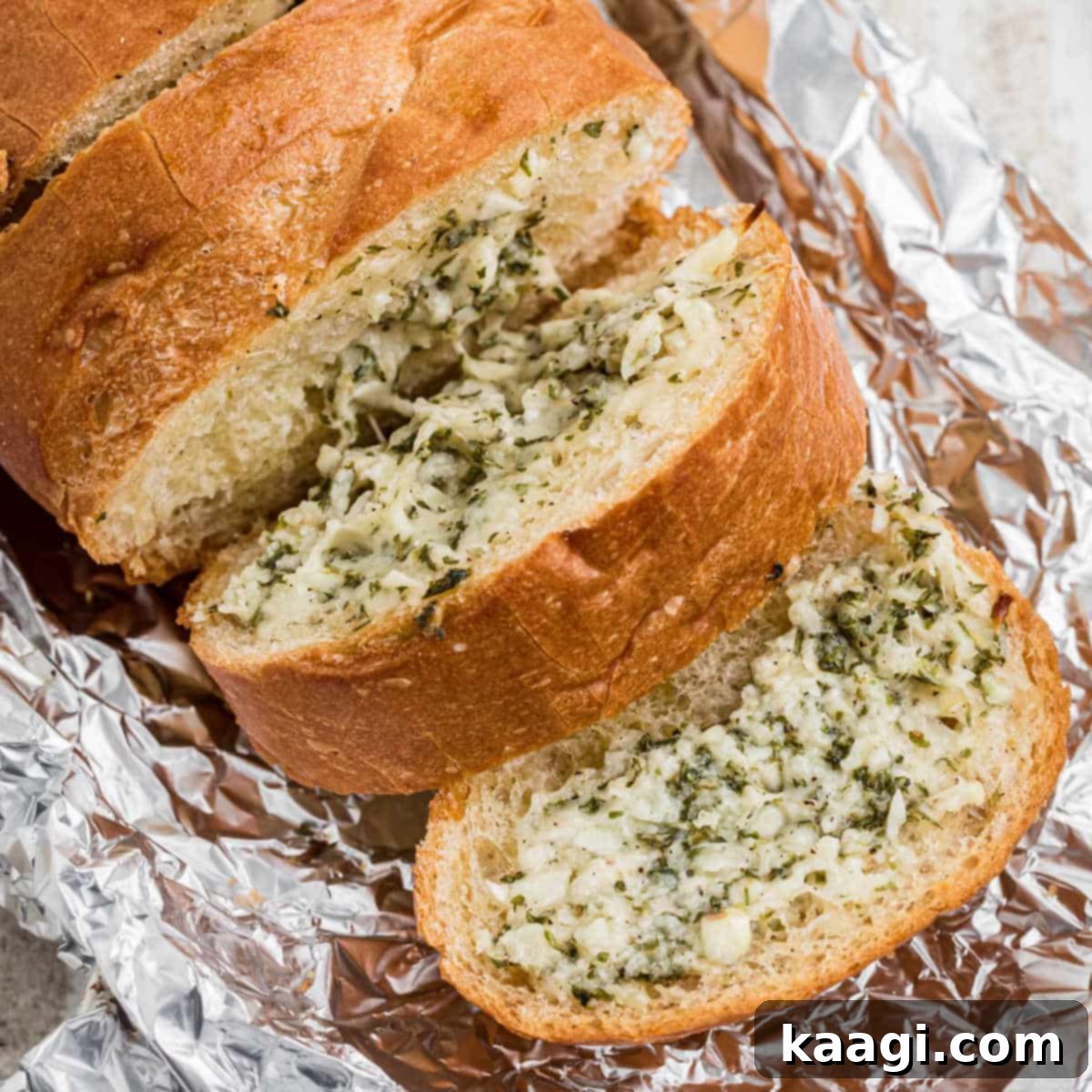 Stuffed garlic bread, slightly opened to reveal its cheesy, garlicky interior.