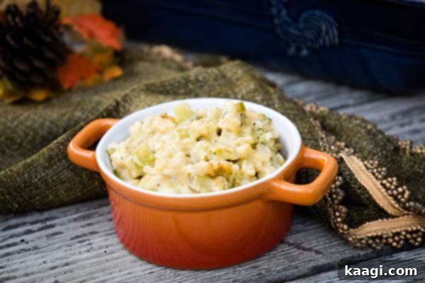 An inviting orange bowl of delicious broccoli and rice casserole, ready to serve.