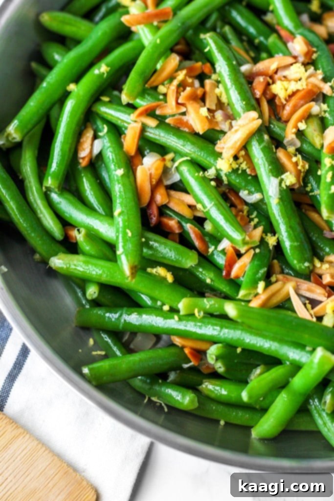 Fresh Green Beans with Toasted Almonds and bright lemon zest, ready to serve.