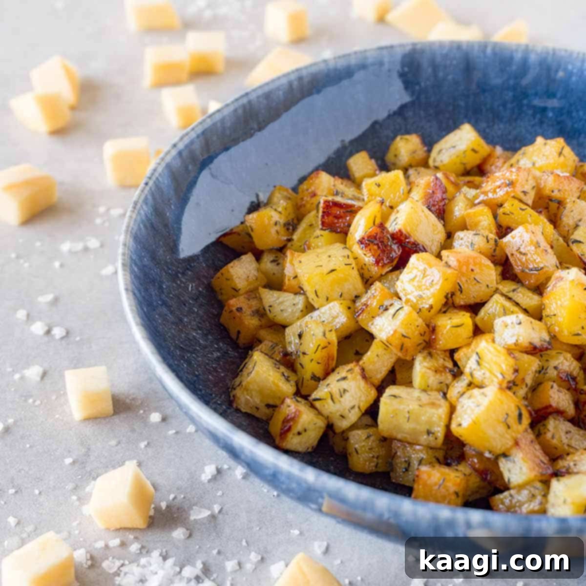 Golden brown oven roasted rutabaga pieces in a bowl, healthy and delicious.