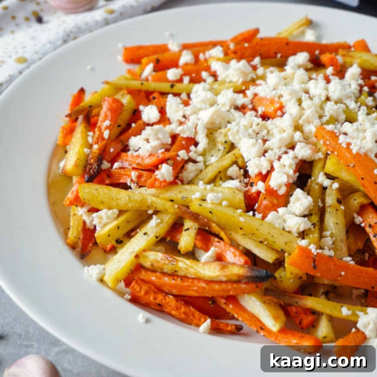Colorful platter of easy roasted carrots and parsnips, seasoned and ready.