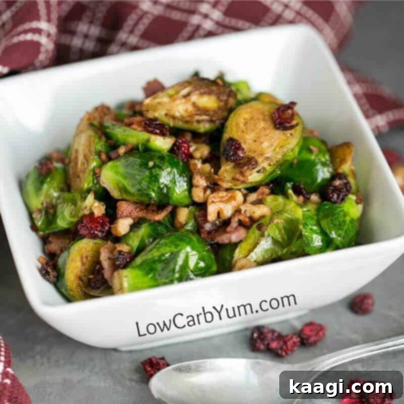 A close-up of pan-fried Brussels sprouts with bacon and cranberries, glistening and tender.