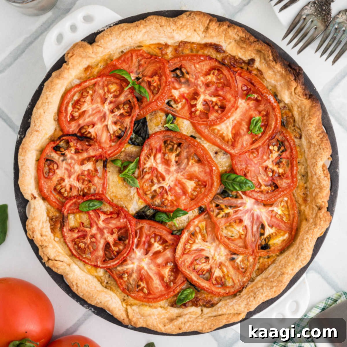 Overhead shot of a golden-crusted Southern tomato pie, brimming with fresh ingredients.