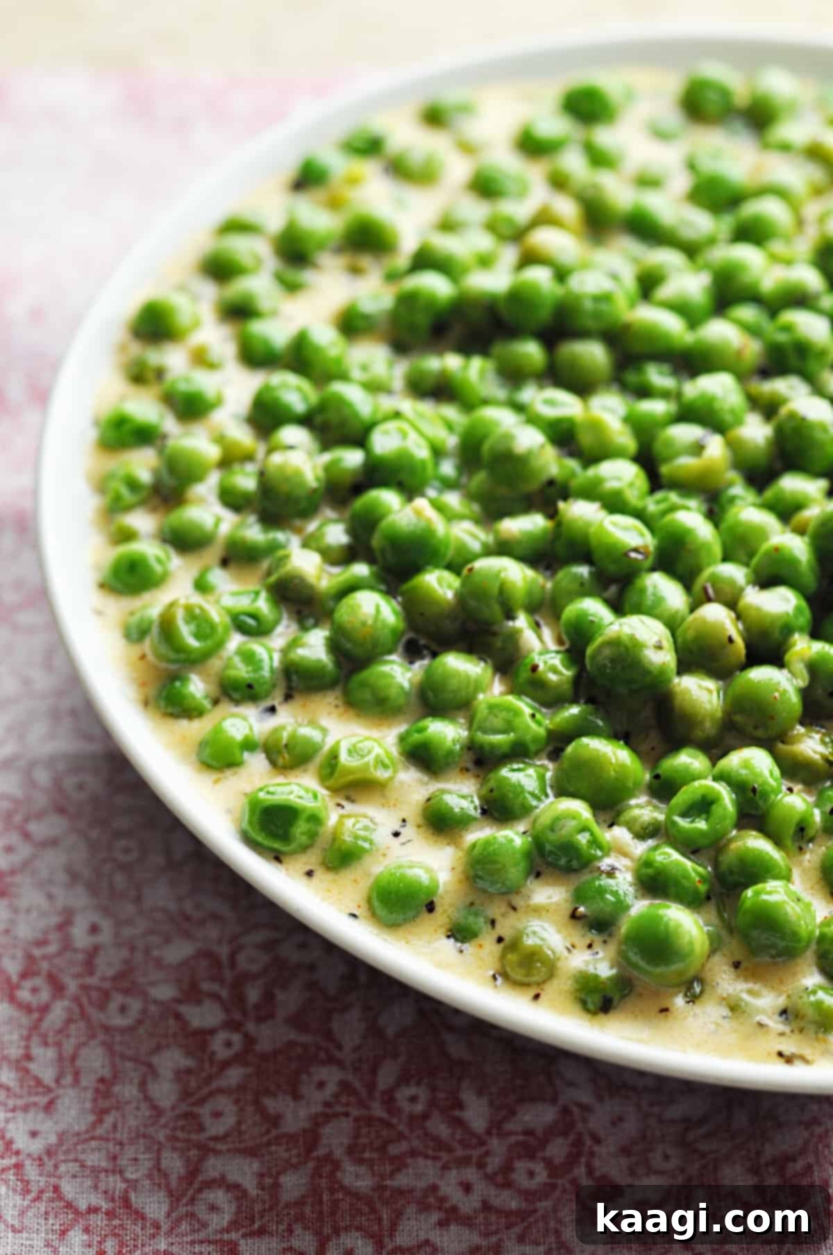 A bowl of rich, creamy peas, an irresistible take on a classic vegetable.
