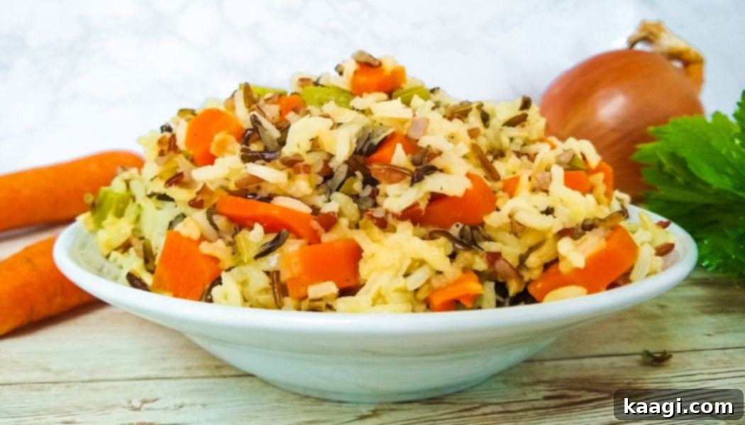 A steaming bowl of one pot wild rice pilaf, rich with vegetables.